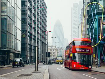 A red London bus driving through London