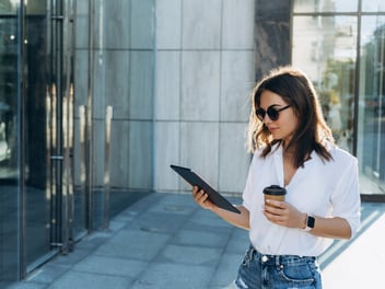 A woman looking at iPad to symbolize digital communication
