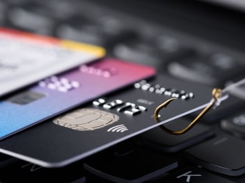 A picture of credit cards and a hook insinuating someone stealing card information