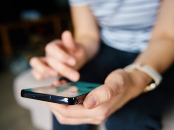 A member on a mobile phone