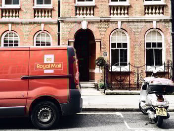 Royal Mail van pictured on street delivering mail