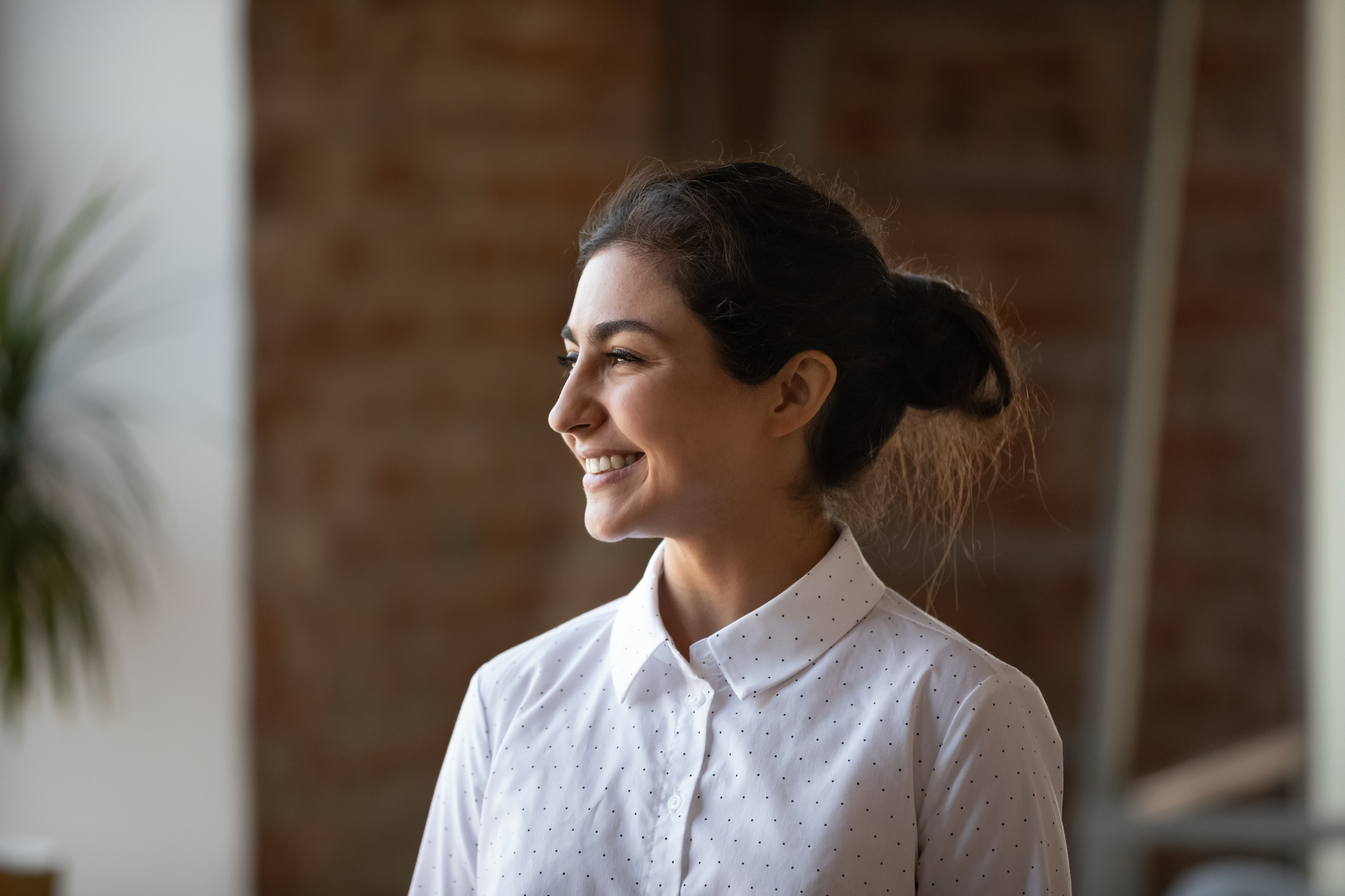 A woman in a white shirt smiling