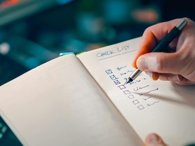 A person with notepad with a checklist open